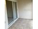 Covered patio showcasing decorative tile flooring and a sliding glass door leading to indoor space at 732 Kensington Lake Cir, Brandon, FL 33511