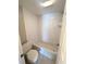 Bathroom with a toilet and shower-tub combo with white tiling at 7506 Presley Pl # 107, Tampa, FL 33617