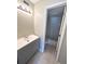 Bathroom with a vanity, light fixture and the doorway to a shower-tub combo at 7506 Presley Pl # 107, Tampa, FL 33617