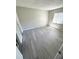 Bedroom featuring laminate flooring, neutral walls, and a window for natural light at 7506 Presley Pl # 107, Tampa, FL 33617