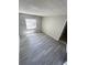 Bedroom featuring laminate flooring, neutral walls, and a window for natural light at 7506 Presley Pl # 107, Tampa, FL 33617