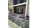 Exterior of building featuring an enclosed patio with a screen, door and grassy area at 7506 Presley Pl # 107, Tampa, FL 33617