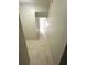 Neutral hallway featuring ceramic tile flooring and access to multiple rooms at 7506 Presley Pl # 107, Tampa, FL 33617
