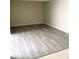 Living room features neutral paint and wood-look flooring; spacious and bright with natural light at 7506 Presley Pl # 107, Tampa, FL 33617