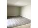 Living room features neutral paint and wood-look flooring; spacious and bright with natural light at 7506 Presley Pl # 107, Tampa, FL 33617
