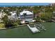 Aerial view of a luxury waterfront estate with a dock, boat lift, and swimming pool at 755 Bay Esplanade, Clearwater Beach, FL 33767