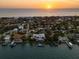 Sunset aerial view of an upscale neighborhood showing the waterfront properties near the Gulf Coast beaches at 755 Bay Esplanade, Clearwater Beach, FL 33767