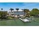 Aerial view of a luxury waterfront estate with a dock, boat lift, and swimming pool at 755 Bay Esplanade, Clearwater Beach, FL 33767