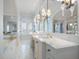 Luxurious bathroom with marble floors, double vanity, and large tub at 755 Bay Esplanade, Clearwater Beach, FL 33767