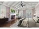 Large bedroom featuring high ceilings, wood floors, a brick fireplace and exterior access at 755 Bay Esplanade, Clearwater Beach, FL 33767