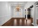 Elegant dining room with coffered ceilings, large windows, and a striking chandelier at 755 Bay Esplanade, Clearwater Beach, FL 33767