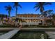 Stunning waterfront home with multi-level porches, lush landscaping, and private dock; a coastal living paradise at 755 Bay Esplanade, Clearwater Beach, FL 33767