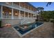 Expansive estate with a pool and spa, illuminated by landscape lighting, creates an inviting atmosphere for evening enjoyment at 755 Bay Esplanade, Clearwater Beach, FL 33767