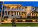 Charming two-story home with columned porch, lush lawn, and manicured landscaping with brick sidewalk at 755 Bay Esplanade, Clearwater Beach, FL 33767