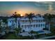 Expansive home featuring a pool, outdoor entertaining area, and palm trees at 755 Bay Esplanade, Clearwater Beach, FL 33767