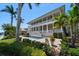 Stately home with a large outdoor pool, manicured lawn, and covered balconies, perfect for upscale waterfront living at 755 Bay Esplanade, Clearwater Beach, FL 33767