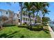 A luxurious waterfront estate with a spacious lawn, a private dock, and a multi-story home perfect for relaxation and entertainment at 755 Bay Esplanade, Clearwater Beach, FL 33767