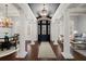 Grand foyer featuring soaring ceilings, elegant columns, dark wood floors and a stylish light fixture at 755 Bay Esplanade, Clearwater Beach, FL 33767