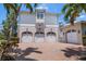 Spacious three-car garage plus single car garage with attractive brick driveway, beautiful landscaping, and ample parking at 755 Bay Esplanade, Clearwater Beach, FL 33767