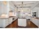Spacious kitchen with white cabinets, an island, and stainless steel appliances at 755 Bay Esplanade, Clearwater Beach, FL 33767