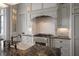 Bright, modern kitchen with white cabinets, stainless steel appliances, and marble countertops at 755 Bay Esplanade, Clearwater Beach, FL 33767