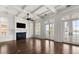 Open living room with a fireplace, coffered ceilings, and doors opening to a scenic balcony at 755 Bay Esplanade, Clearwater Beach, FL 33767