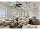 Elegant living room with cream furnishings, dark wood floors, and an exquisite area rug at 755 Bay Esplanade, Clearwater Beach, FL 33767
