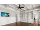 Bright home office with a custom built-in bookshelf, ladder, and a modern ceiling fan at 755 Bay Esplanade, Clearwater Beach, FL 33767