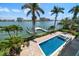 Swimming pool and dock with bay views on a sunny day at 755 Bay Esplanade, Clearwater Beach, FL 33767
