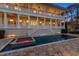 Backyard pool with adjoining spa featuring travertine tile surround and views of the rear of the house at 755 Bay Esplanade, Clearwater Beach, FL 33767