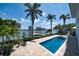Backyard pool with dock overlooking the bay and city skyline at 755 Bay Esplanade, Clearwater Beach, FL 33767