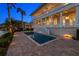 Beautiful backyard with a sparkling pool, spa, manicured lawn, and lush landscaping by the water at 755 Bay Esplanade, Clearwater Beach, FL 33767