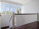 Bright staircase with hardwood floors and white railings at 755 Bay Esplanade, Clearwater Beach, FL 33767