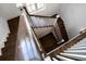 Hardwood staircase with white railings and an open design at 755 Bay Esplanade, Clearwater Beach, FL 33767