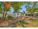 Detached accessory structure in a spacious backyard with shade from mature trees at 8444 8Th N Way, St Petersburg, FL 33702