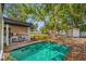 Backyard featuring a detached accessory structure, trees, and lawn at 8444 8Th N Way, St Petersburg, FL 33702
