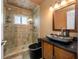 Bathroom features a modern sink, vanity, and glass-enclosed shower with shelving at 8444 8Th N Way, St Petersburg, FL 33702