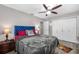 Cozy bedroom with a large bed, ceiling fan, and closet space at 8444 8Th N Way, St Petersburg, FL 33702