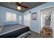 Cozy bedroom features a ceiling fan, closet, and light-blue-painted walls at 8444 8Th N Way, St Petersburg, FL 33702