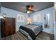 Bedroom with wood floors, shutters, ceiling fan and accent mirror at 8444 8Th N Way, St Petersburg, FL 33702
