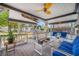 Inviting covered patio with stylish seating, a ceiling fan, and a peaceful view of the backyard at 8444 8Th N Way, St Petersburg, FL 33702