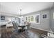 Inviting dining area with shuttered windows, a stylish glass table, and flows seamlessly into the living spaces at 8444 8Th N Way, St Petersburg, FL 33702