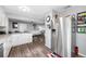 Spacious kitchen with white cabinets, wood flooring, and stainless steel refrigerator at 8444 8Th N Way, St Petersburg, FL 33702