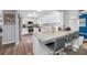 Modern kitchen featuring granite countertops, stainless steel appliances, white cabinetry, and barstool seating at 8444 8Th N Way, St Petersburg, FL 33702