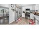 Modern kitchen featuring stainless steel appliances, wood flooring and adjacent breakfast nook at 8444 8Th N Way, St Petersburg, FL 33702