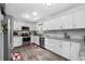 Bright kitchen with white cabinets, stainless steel appliances, light countertops, and wood flooring at 8444 8Th N Way, St Petersburg, FL 33702