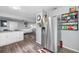 Open-concept kitchen featuring stainless steel refrigerator and views of the living area at 8444 8Th N Way, St Petersburg, FL 33702