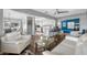 Spacious living room showcasing an open layout with a kitchen island, sleek furnishings, and modern gray color scheme at 8444 8Th N Way, St Petersburg, FL 33702