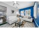 Cozy living room featuring tile flooring, modern furniture, and a view into the next room at 8444 8Th N Way, St Petersburg, FL 33702
