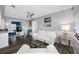 Bright living room featuring a ceiling fan, minimalist decor, and seamless flow into the adjacent kitchen and entertainment area at 8444 8Th N Way, St Petersburg, FL 33702